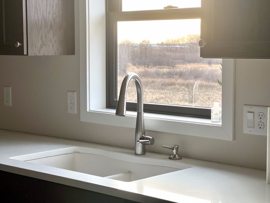 A scenic view outside of a kitchen window. This home was built by Due North Homes, LLC.